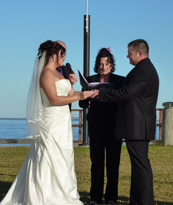 Leisha and Jeff Exchange Rings at Woody Point on the Redcliffe Peninsularwith Marilyn Verschuure from Marry Me Marilyn